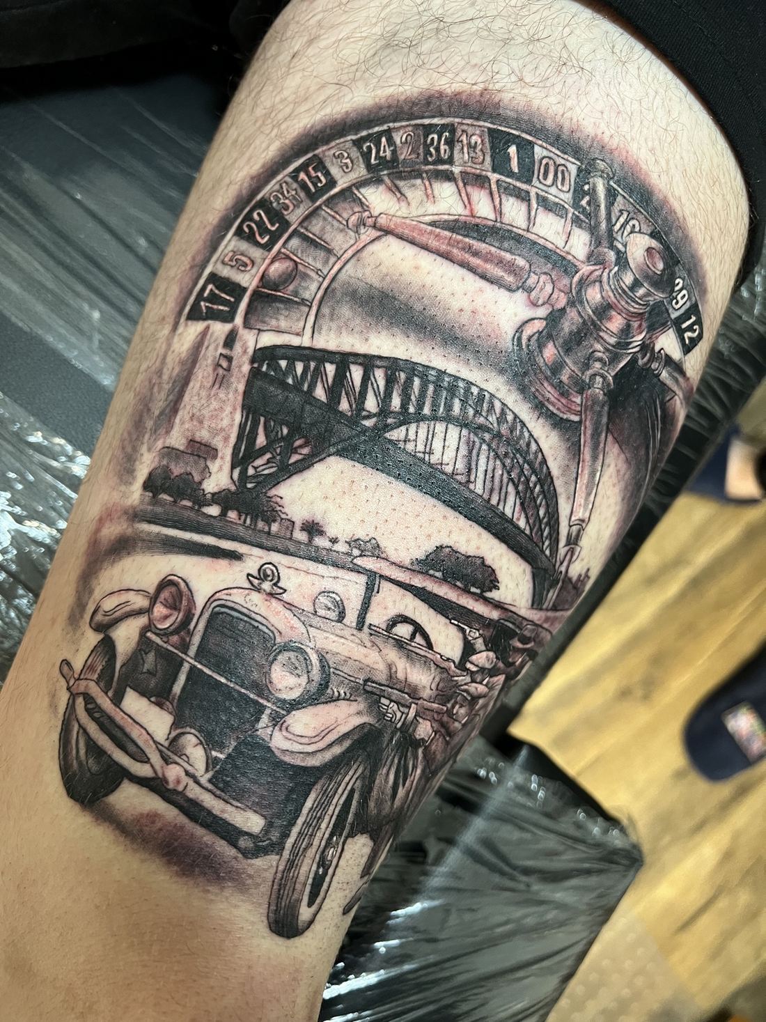 Tattoo: Black & grey realism — Roulette, bridge and classic car