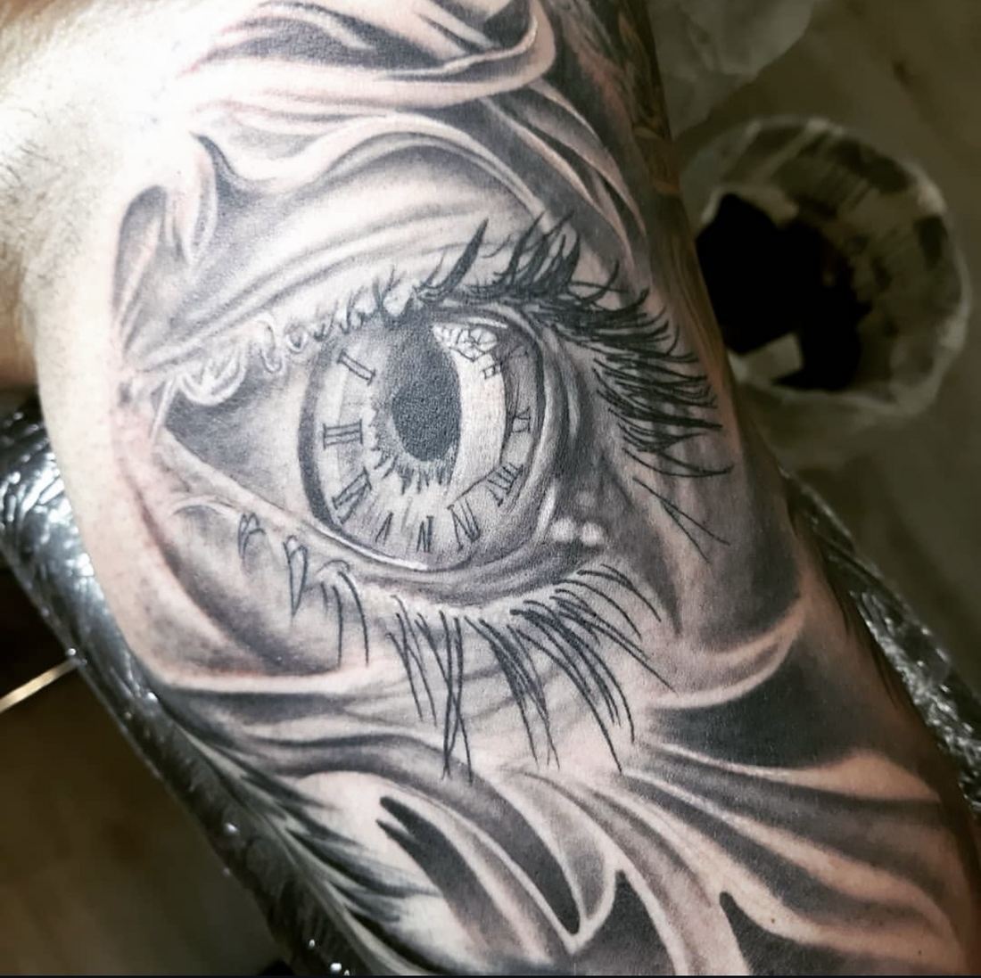 Tattoo: Black & grey realism — Eye and clock face